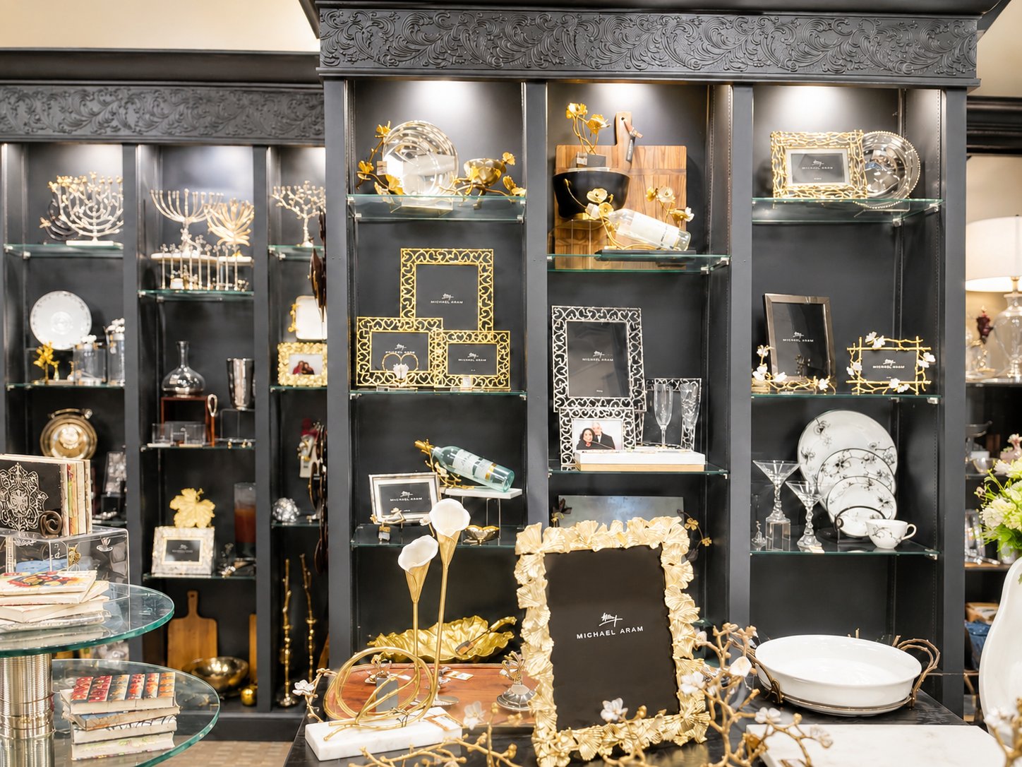 Michael Aram frames, crystal, and curated home décor in dark gallery shelving at The Things I Love
