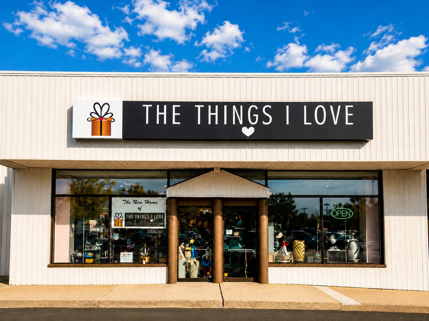 The Things I Love storefront on South Main Street in New City, NY — the boutique sign with the gift box logo on a clear blue-sky morning